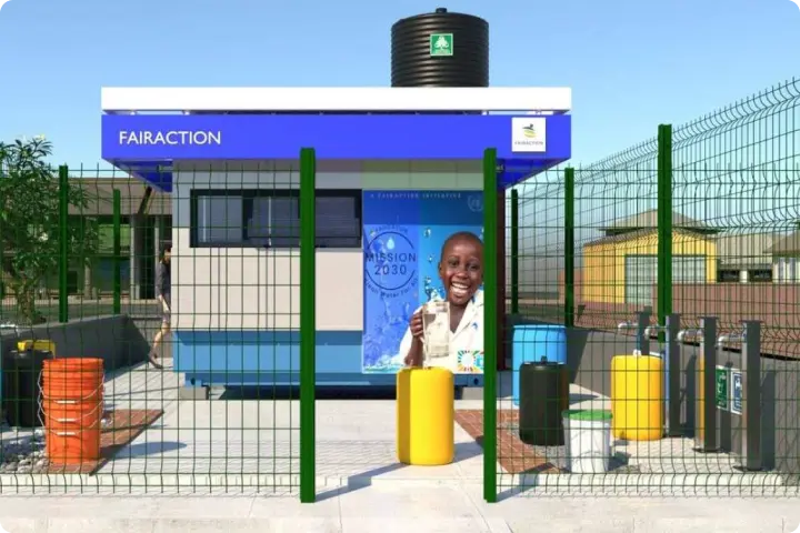 A small water treatment facility with a blue and white structure, fenced area, barrels, and a poster of a smiling person holding a water bottle.