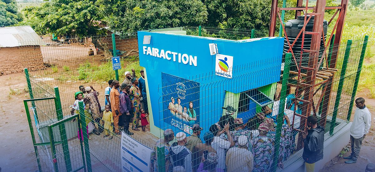 Community members gather at a Fairaction Smart Water Solution kiosk in Boni, Igboho, Oyo State, Nigeria. The photo shows the hardware; the research, monitoring and live reporting that keep it running are not visible.